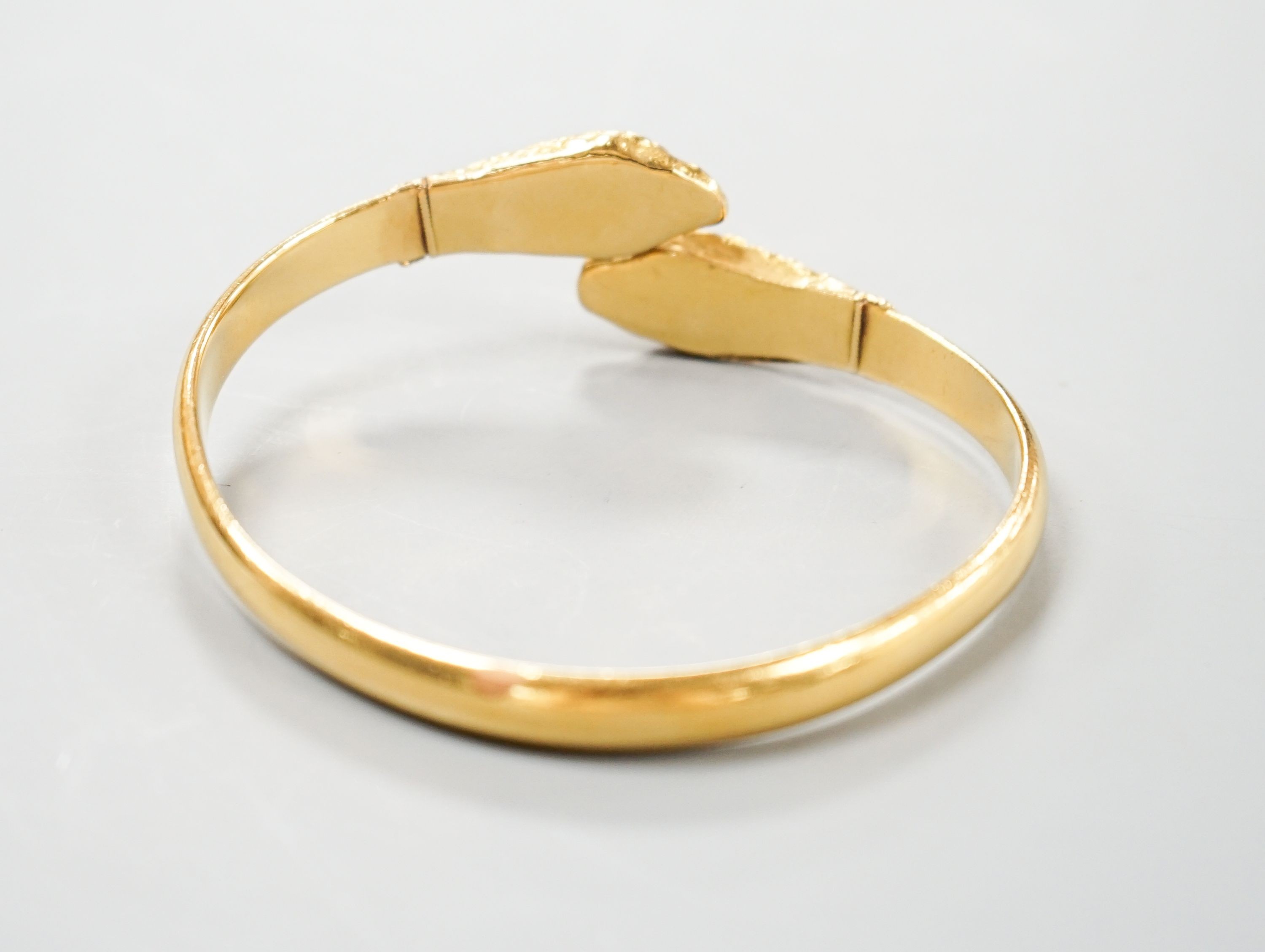 An Indian yellow metal twin headed serpent bangle